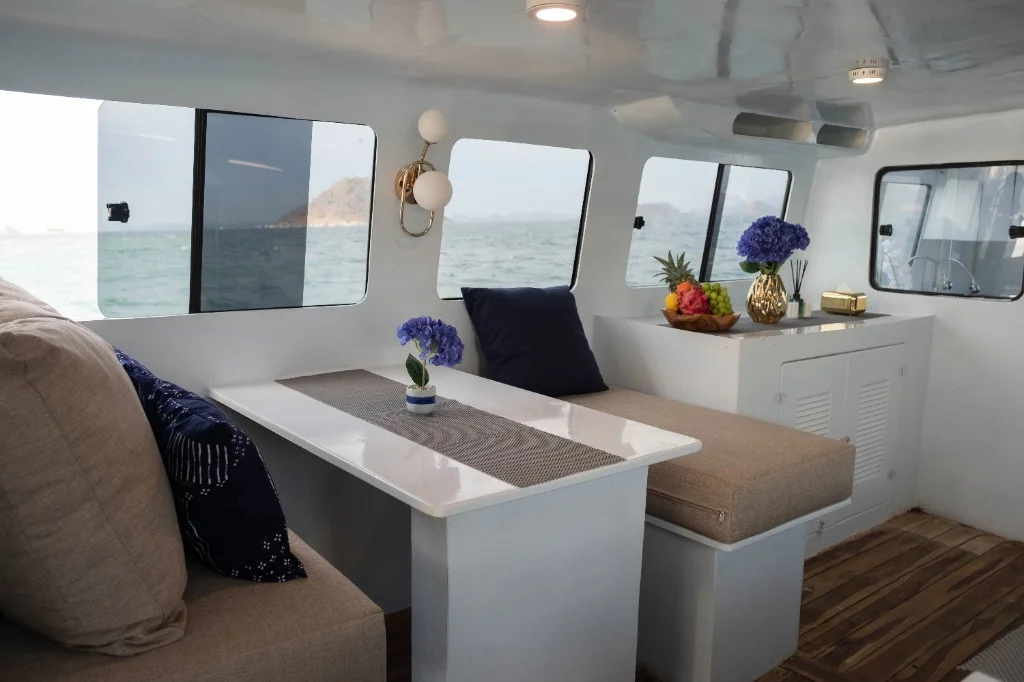 Luxury indoor lounge of Speedboat D with fresh fruits and blue flowers