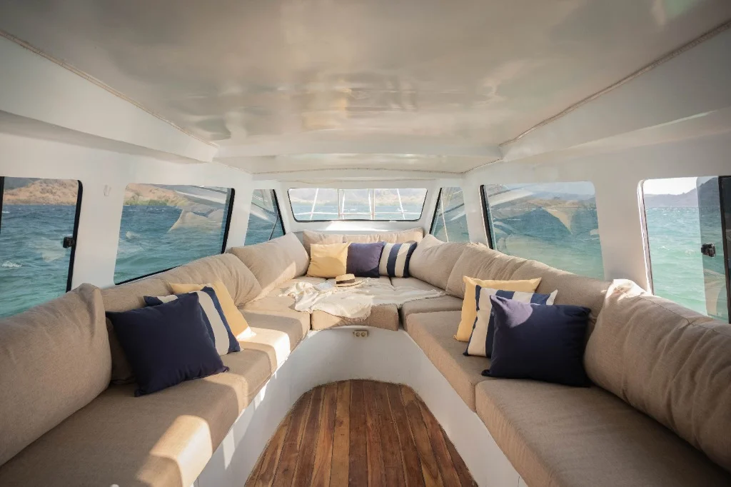 Spacious indoor seating area on Speedboat D for group comfort